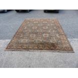 A large geometric brown, black and cream ground, bordered, patterned and fringed Carpet,