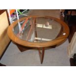 A mid century glass topped table.