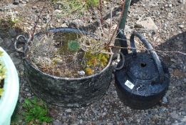 An Aga kettle and cook-pot with plants.