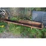 A cast iron pig trough with damage 14" wide x 73" long.