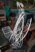 A white painted iron garden feature frame plus 2 metal baskets and a wrought iron hanging candle