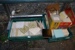 Three boxes of tiles, various sizes and patterns.