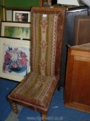 A tall backed nursing chair with tapestry seat.