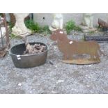 An iron cut-out figure of a Dog and an oval brass cooking pot with iron swing handle.