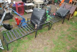 Two metal loungers with cushions.