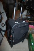 A black wheeled 'Kipling' travel bag with 2 handbags and purse, all in good condition.