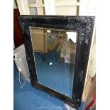 A large black framed bevelled Mirror, 45'' high x 33'' wide.