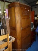 A dark wood gents wardrobe with fretwork detail, 72" high x 35" wide x 15" deep.