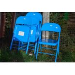 Four metal folding chairs.