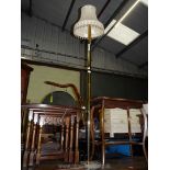 A brass standard lamp and shade.