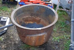 A large cast iron boiler pot, cracked.