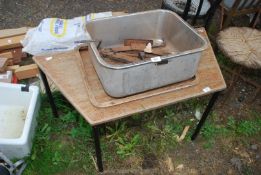 A stainless steel sink and car jack.