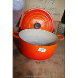 A Le Creuset lidded Casserole dish, orange.