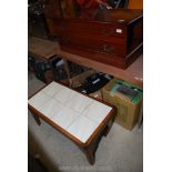 A TV cabinet and a tiled top coffee table.