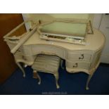 A cream painted kidney shaped dressing table with triptych mirror and stool.