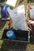 A sack of bird feed, a planter and camping gas.