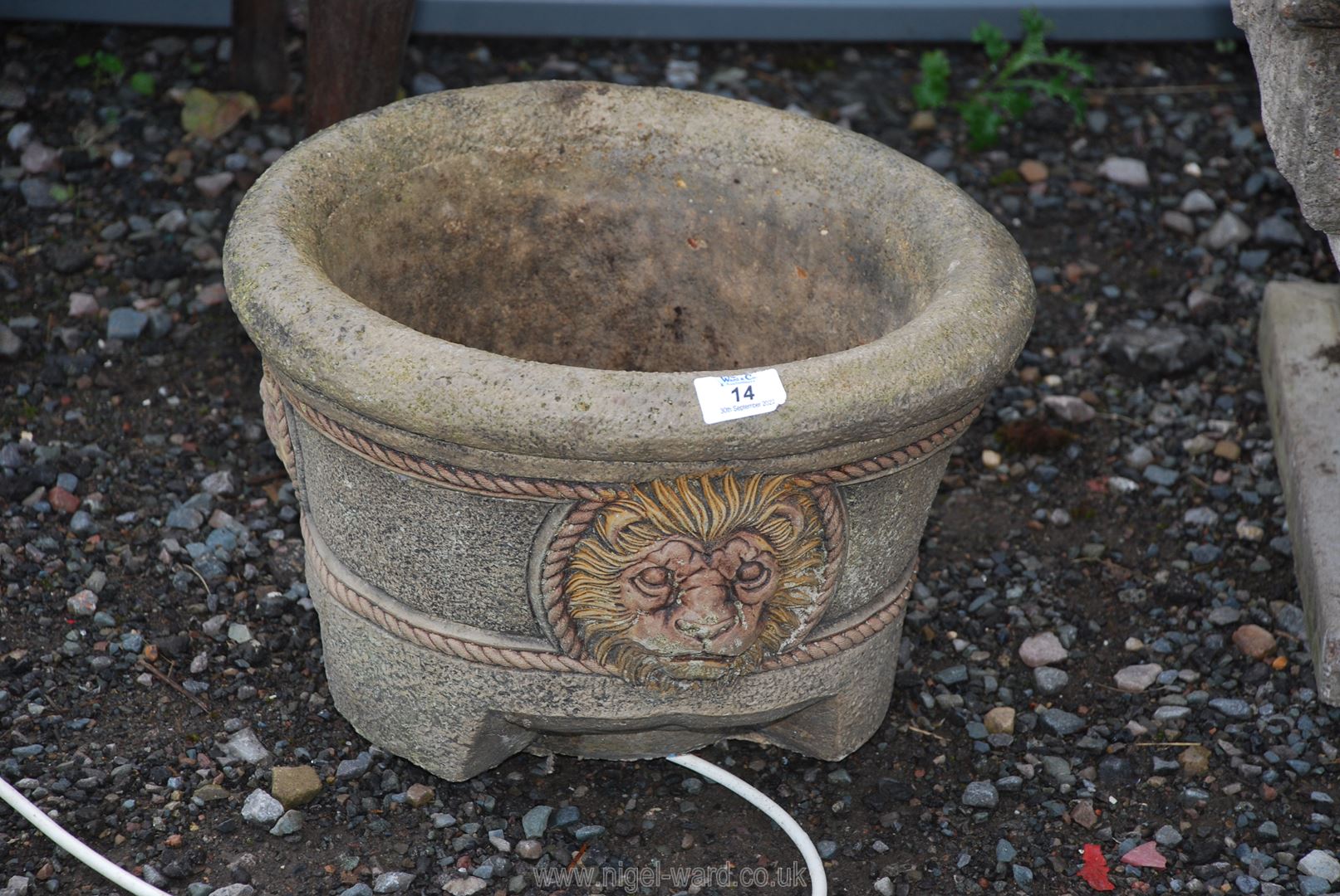 A circular concrete Planter with lion mask decoration, 14'' diameter x 10'' high.