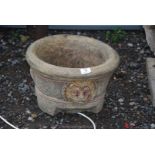 A circular concrete Planter with lion mask decoration, 14'' diameter x 10'' high.