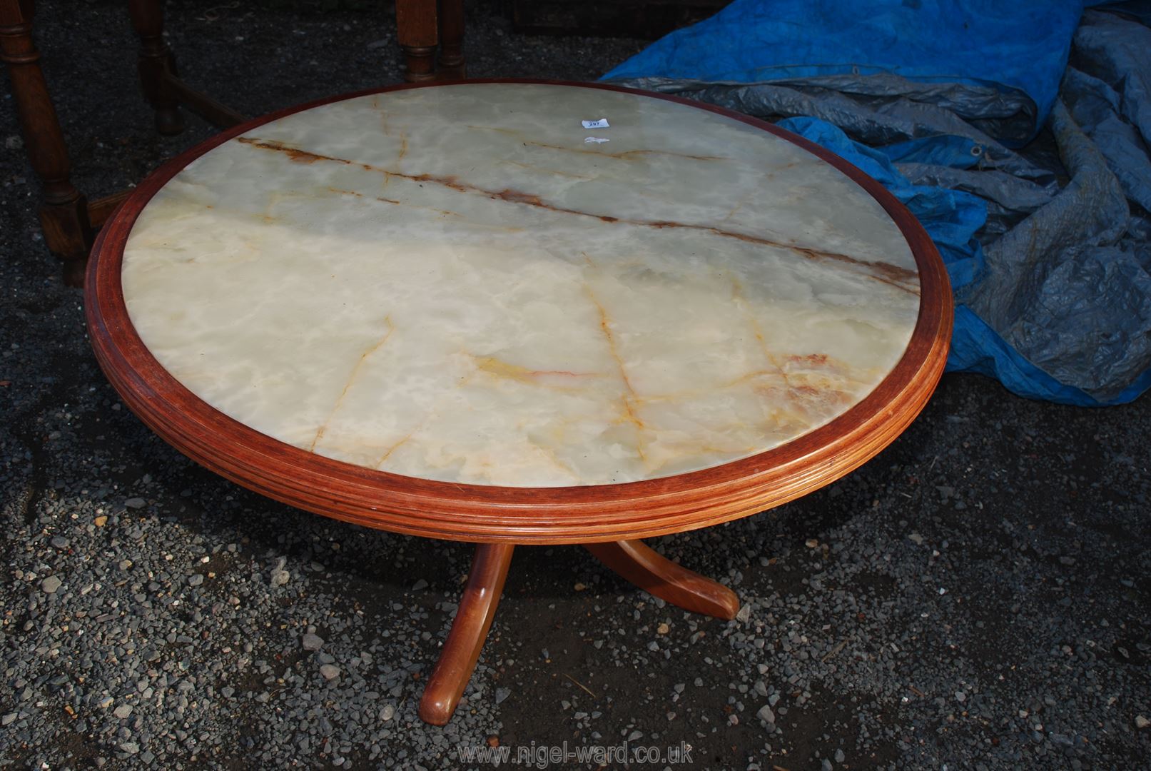 A low circular coffee table with onyx top, 41" diameter x 22" high.