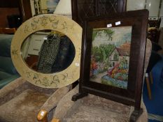 A large wooden framed oval Mirror, 41'' x 31 1/2', and a tapestry firescreen.