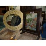 A large wooden framed oval Mirror, 41'' x 31 1/2', and a tapestry firescreen.