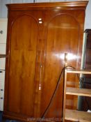 A large walnut style double wardrobe.