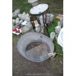 A metal wash stand with enamel basin and large galvanised bath.