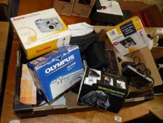 A box of assorted cameras, Sat Nav, etc.