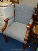 A blue upholstered arm chair.