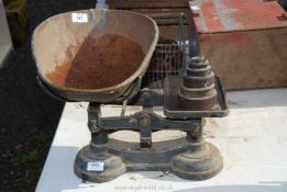 A set of vegetable Scales and six weights, plus a cooking pot.