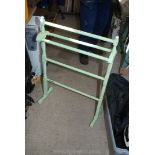 A wooden painted towel rail.