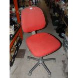 Red swivel office chair.