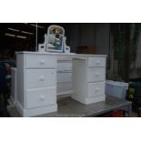 Two dressing tables (one with mirror), bedside table and chest of drawers.