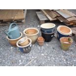 A quantity of glazed pots and a watering can.