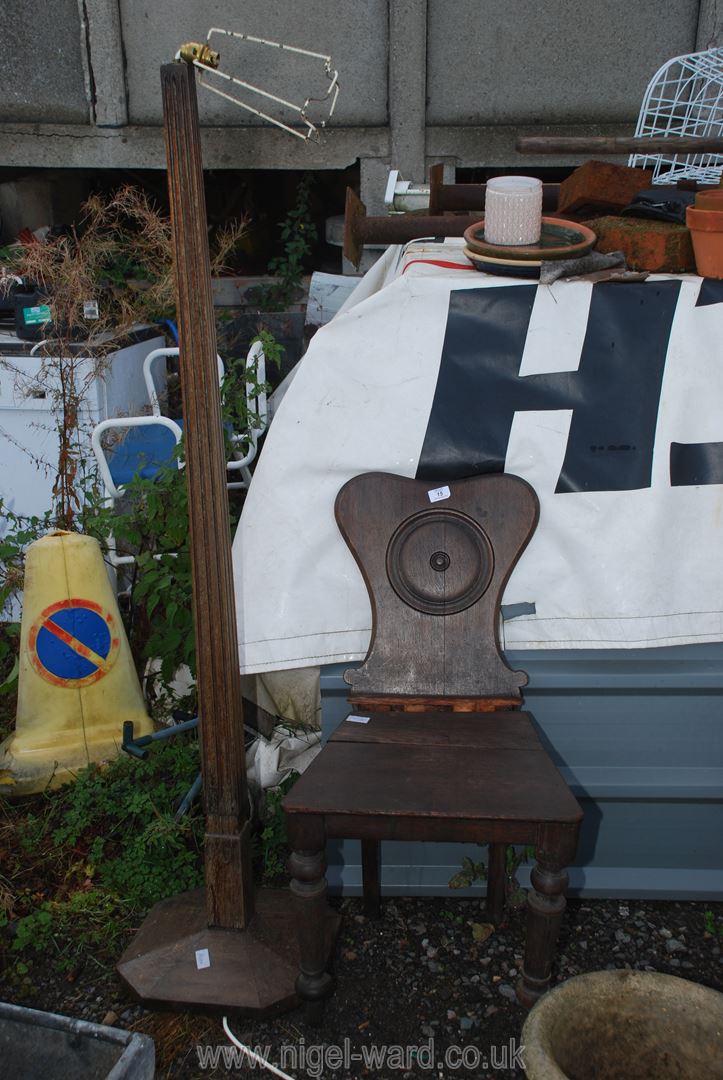 A wooden standard lamp and a hall chair in need of restoration.