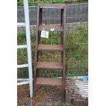 A metal five rung step ladder.