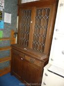 A rustic dark wood cabinet with lead glazed top a/f.