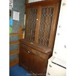 A rustic dark wood cabinet with lead glazed top a/f.