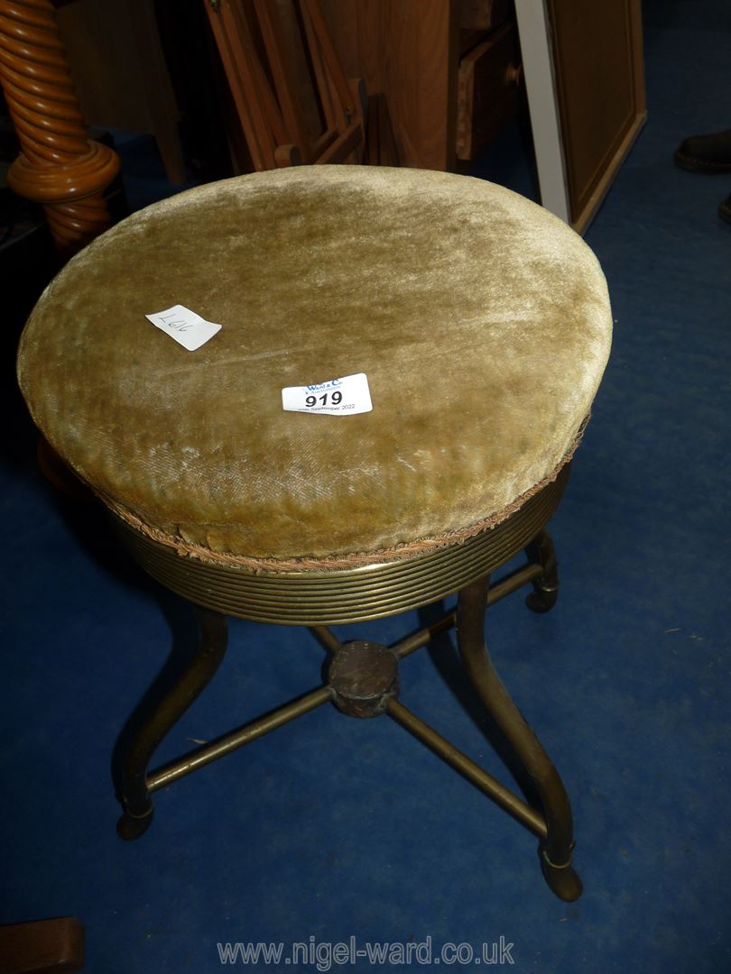 A swivel top piano stool with metal base, 19" tall.