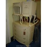 A cream painted chest of drawers and pair of matching beside cabinets,