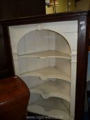 A large dark wood corner cabinet with white painted interior, 57 1/2" high x 43" wide x 29" deep.