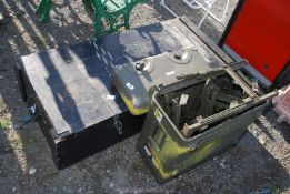 A military trunk and a wooden trunk and folding steel legs.