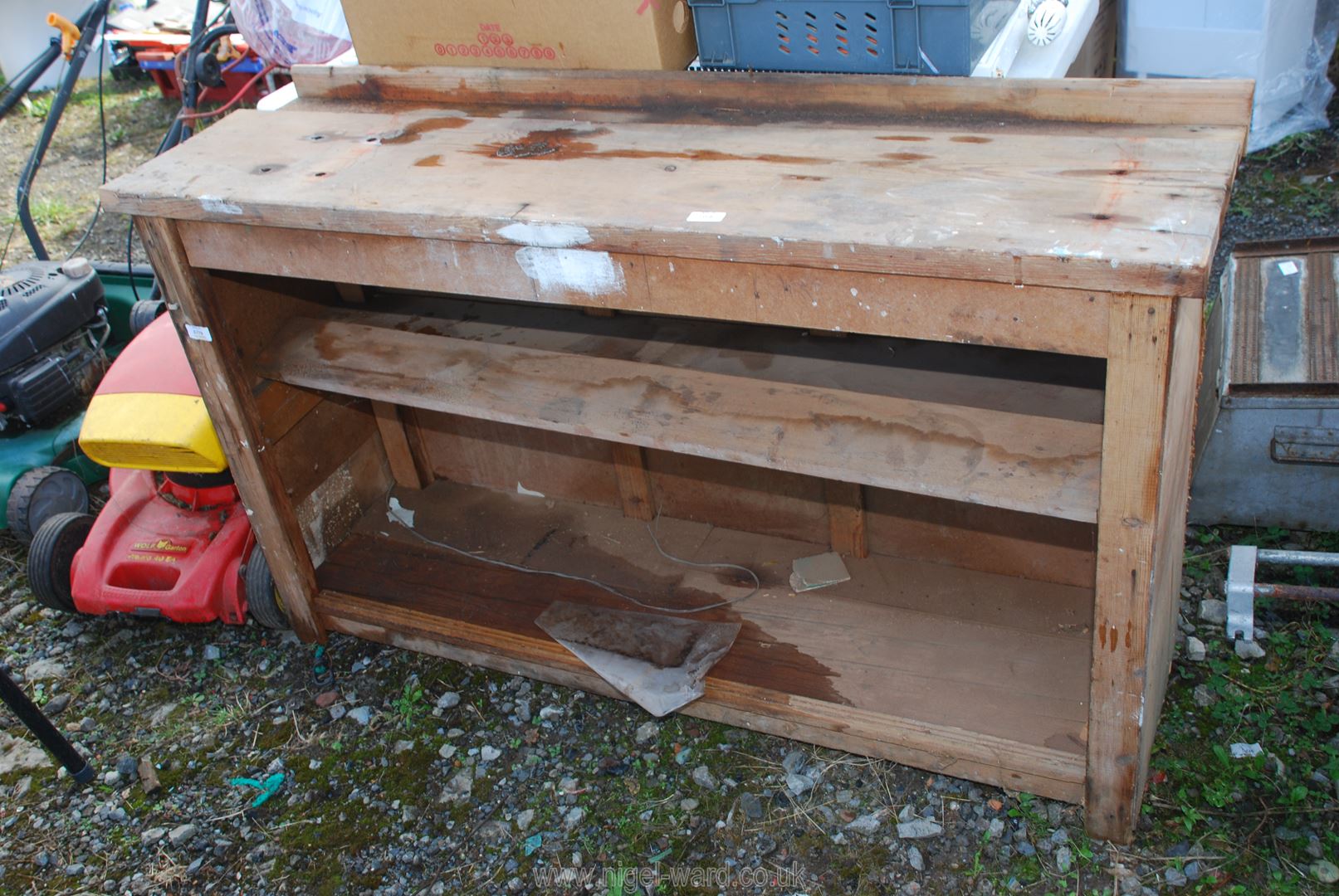 A wooden work bench with shelves, 53" wide x 15" deep x 31" high.