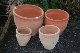 Four terracotta planters.