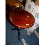 A dark wood circular occasional table in Indoneesian wood