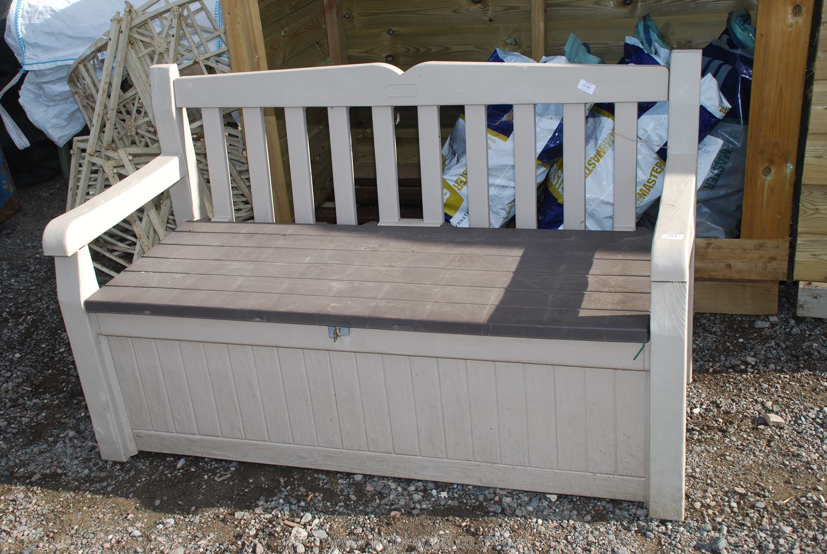 A "Keter" storage bench and contents, 55" wide x 33" high.