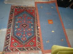 A small wool carpet with border and fringing 49" x 29",