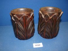 A pair of 19th century Chinese turned and carved hardwood brush Pots in the form of lotus flowers,