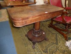 A 19th century Rosewood and Mahogany flap over Tea Table having a tapering turned pillar,