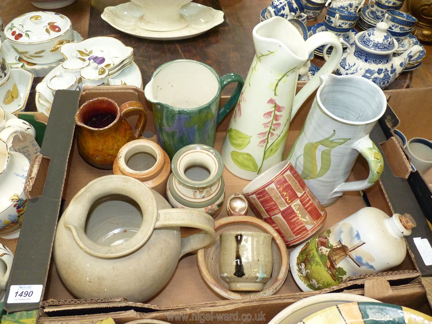 A quantity of pottery jugs including; a hand painted Foxglove jug, hand painted harebell jug,